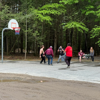 Children playing basketball on a court.