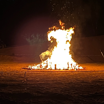 A large bon fire in a field.