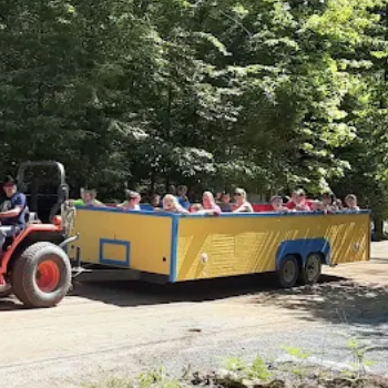 Children on a wagon ride being pulled by a tractor.