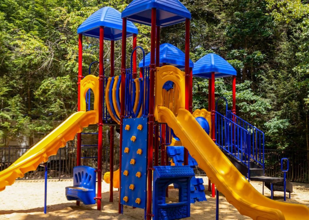 Children climbing on a playground at Friendly Beaver Campground