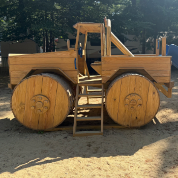 Wooden representation of a monster truck meant for children to play on.