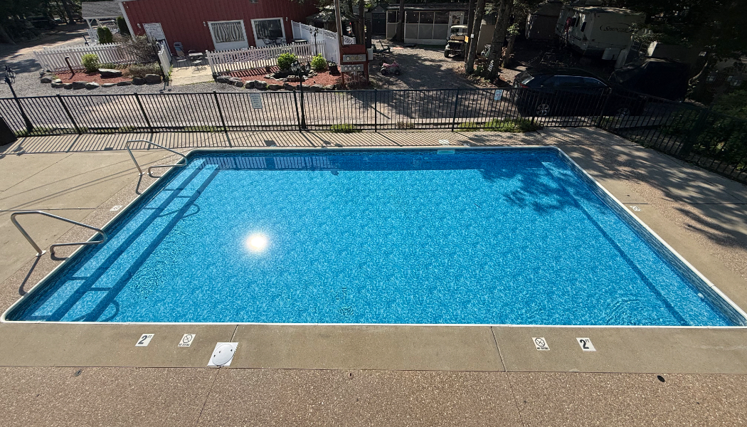 Outdoor pool that is shallow with steps on the side.
