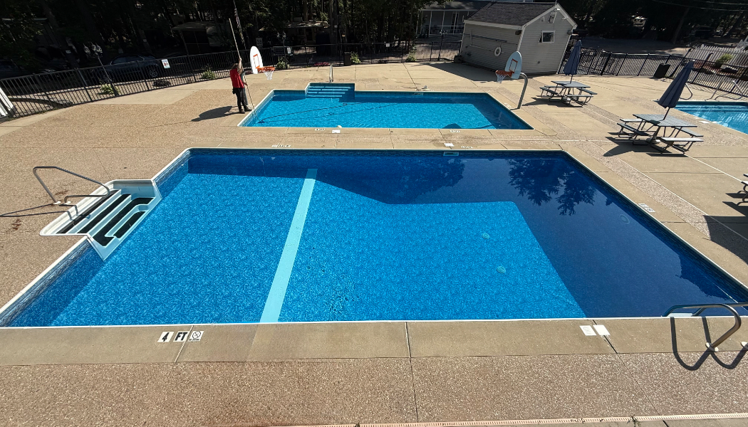 Outdoor pool with stairs on the side.