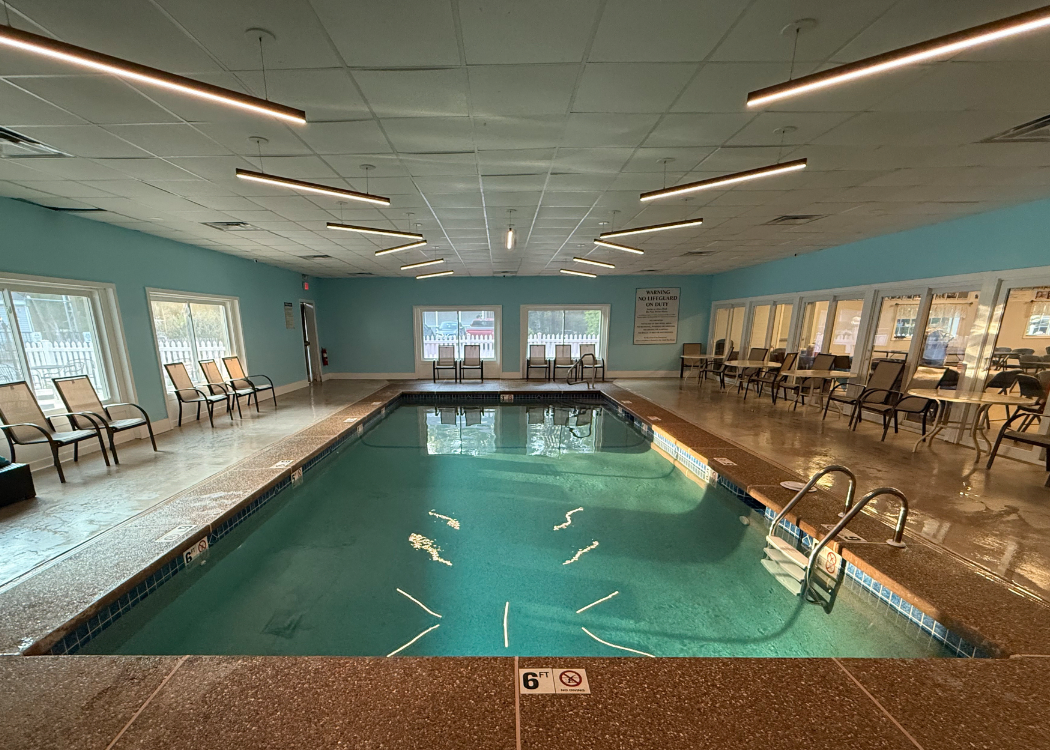 Indoor pool with charis around the edges.